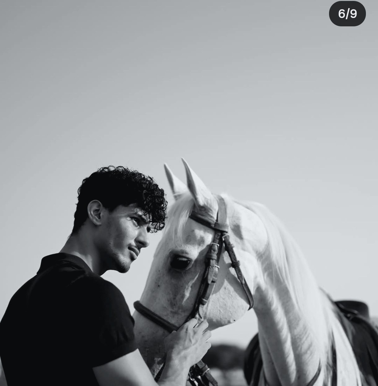 Abdul Ahad standing with his horse